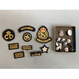 Twenty four badges including Warwickshire Defence Corps, warden, first aid, etc, as well as Air Raid