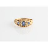 An 18ct yellow gold sapphire and diamond ring, set with three principal sapphires and four diamond