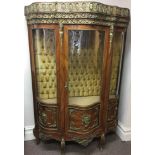 A Louis XV style kingwood shaped front display cabinet, with glazed single door and brass trim.