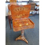 A Victorian walnut fitted sewing table on turned central pillar and tri form base.