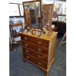 A reproduction mahogany chest of four long drawers and two mahogany framed swing mirrors.