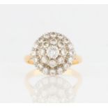 A three tier diamond cluster ring, set with three graduated tiers of round brilliant cut diamonds,