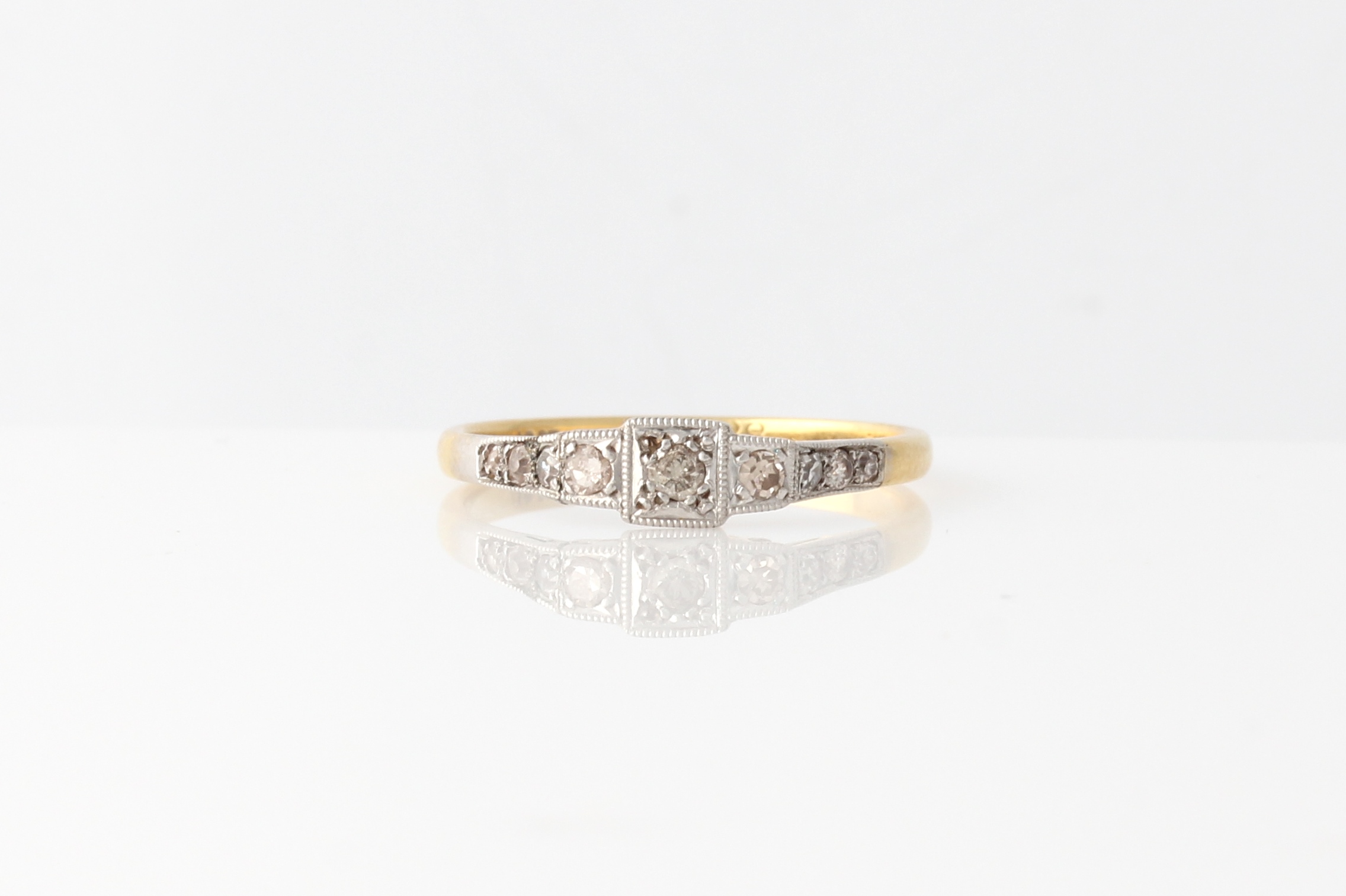 An early 20th Century diamond ring, set with three principal eight-cut diamonds, with further