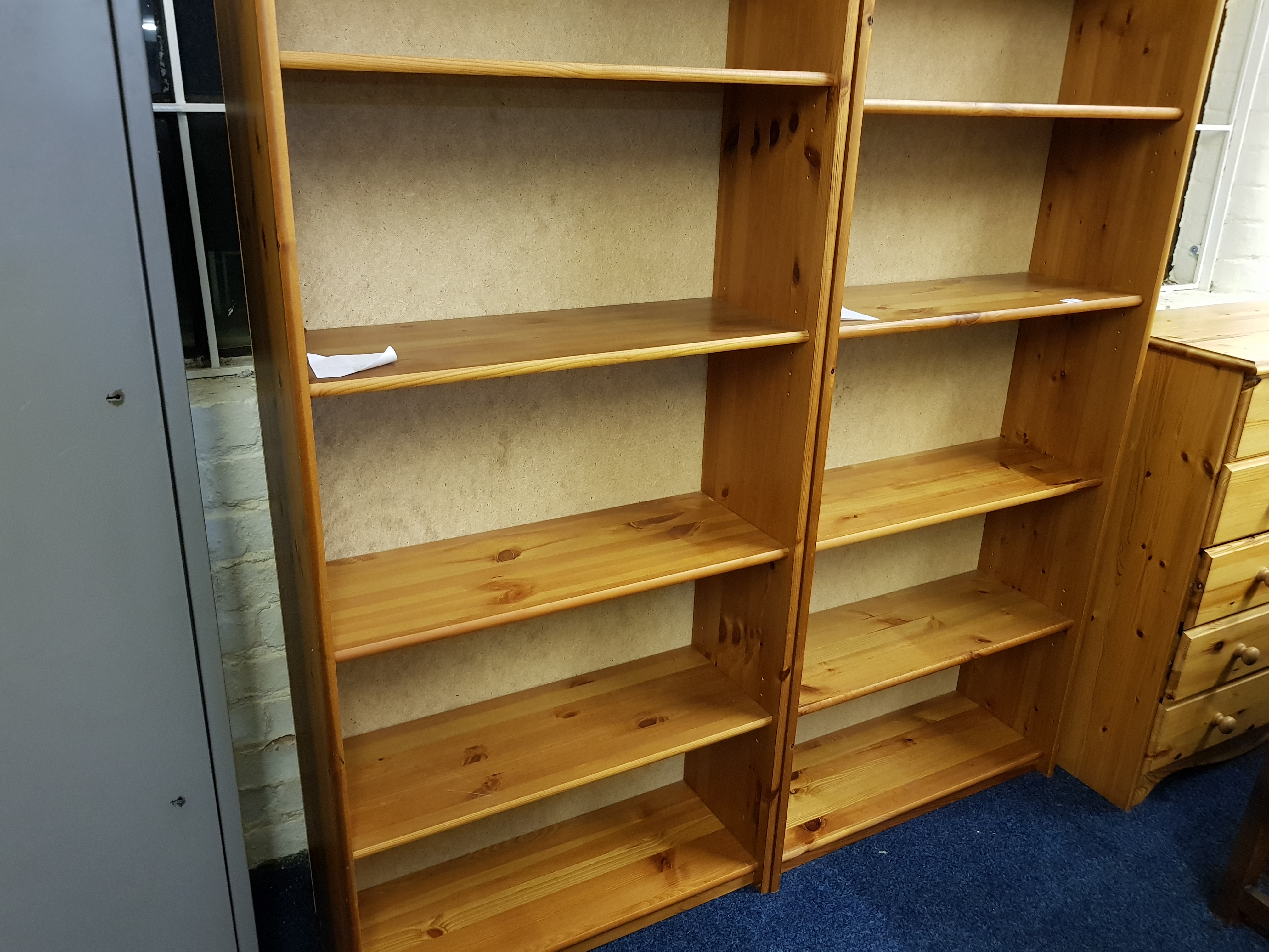 Two pine free-standing bookshelves.