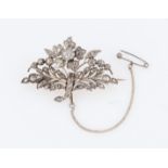 An 'en tremblent' diamond set brooch, the floral and foliage design set with variously size rose cut