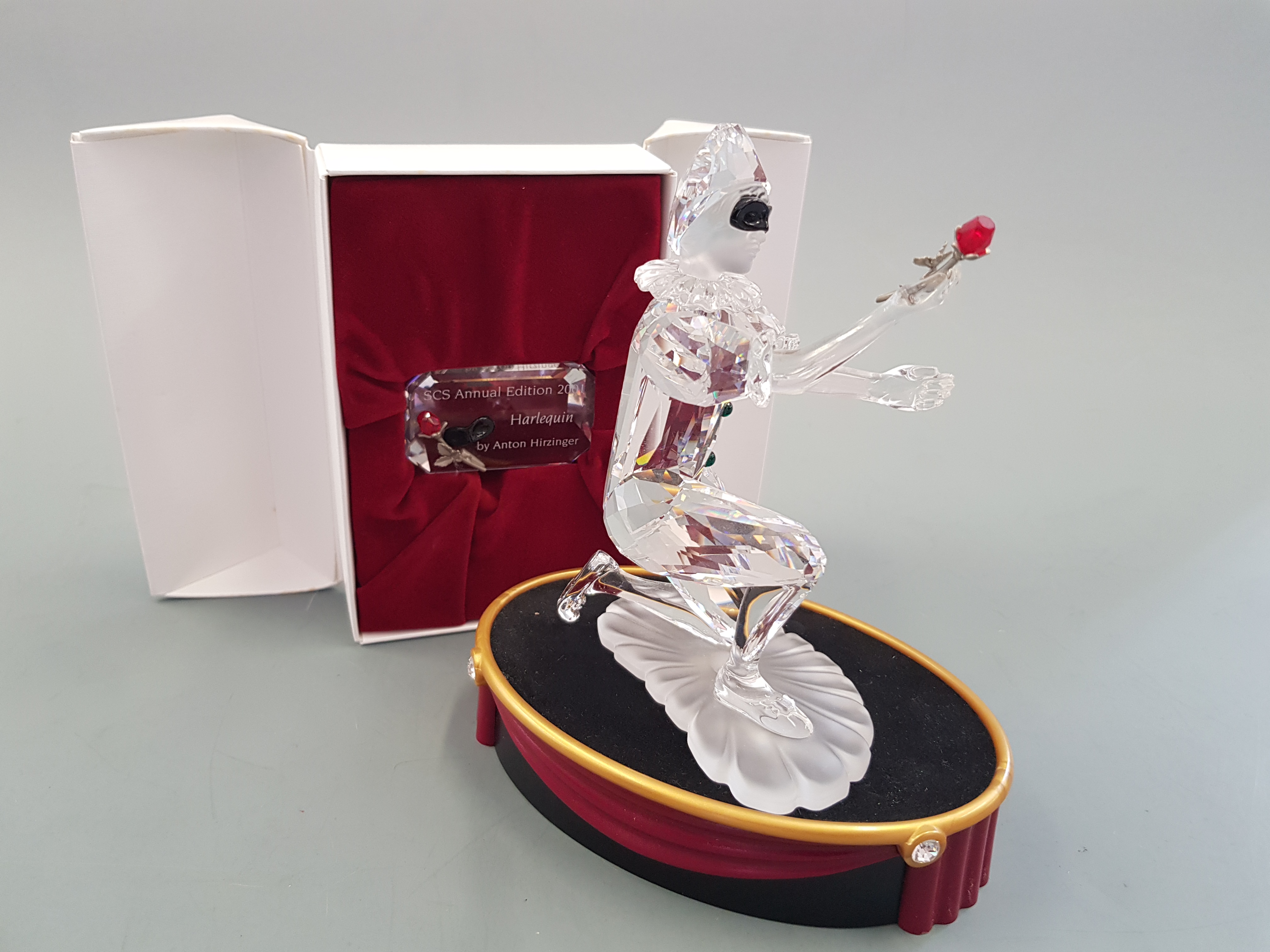 A boxed Swarovski figure 2001, masquerade Harlequin with stand and name plaque, by Anton Hirzinger.