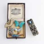 A collection of five brooches, including four being enamelled, together with a stone set lipstick