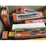 A box of Limo loco model trains and track with various other models.