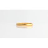 A hallmarked 22ct yellow gold plain wedding band.