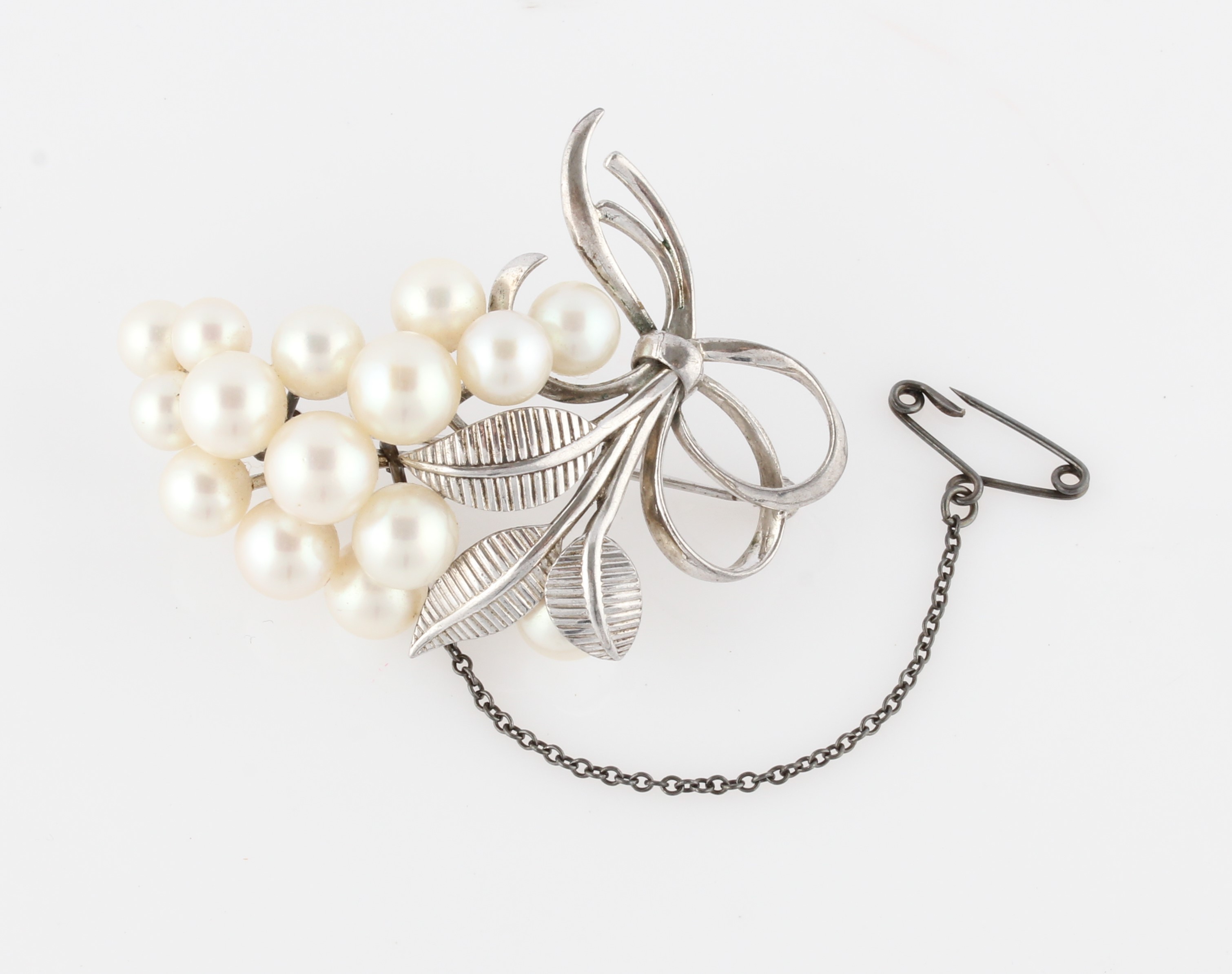 A Mikimoto pearl brooch, set with fifteen variously sized pearls, smallest measuring approx. 5.5mm