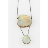 An opal necklet, set with an irregular shaped piece of opal, measures approx. 23x22mm, suspending