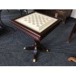 A mahogany reproduction chess table with simulated ivory top and set of Chinese resin chess pieces