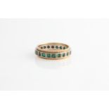 A green stone full eternity ring, hallmark indistinct, ring size O½.