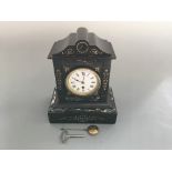 A slate cased mantel clock with marble and gold painted detail including key and pendulum. Height