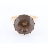 A 9ct yellow gold smoky quartz dress ring, set with a round cut smoky quartz, measuring approx.