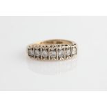A hallmarked 9ct yellow gold seven stone diamond ring, set with seven round brilliant cut
