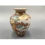A gold and orange painted oriental vase with floral design, with character marks to base. Height