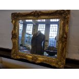 A 19th century gilt frame with replacement bevel edge mirror.