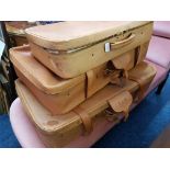 A set of three pig skin graduated suitcases.