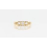 A hallmarked 18ct yellow gold three stone diamond ring, set with three graduated round brilliant cut