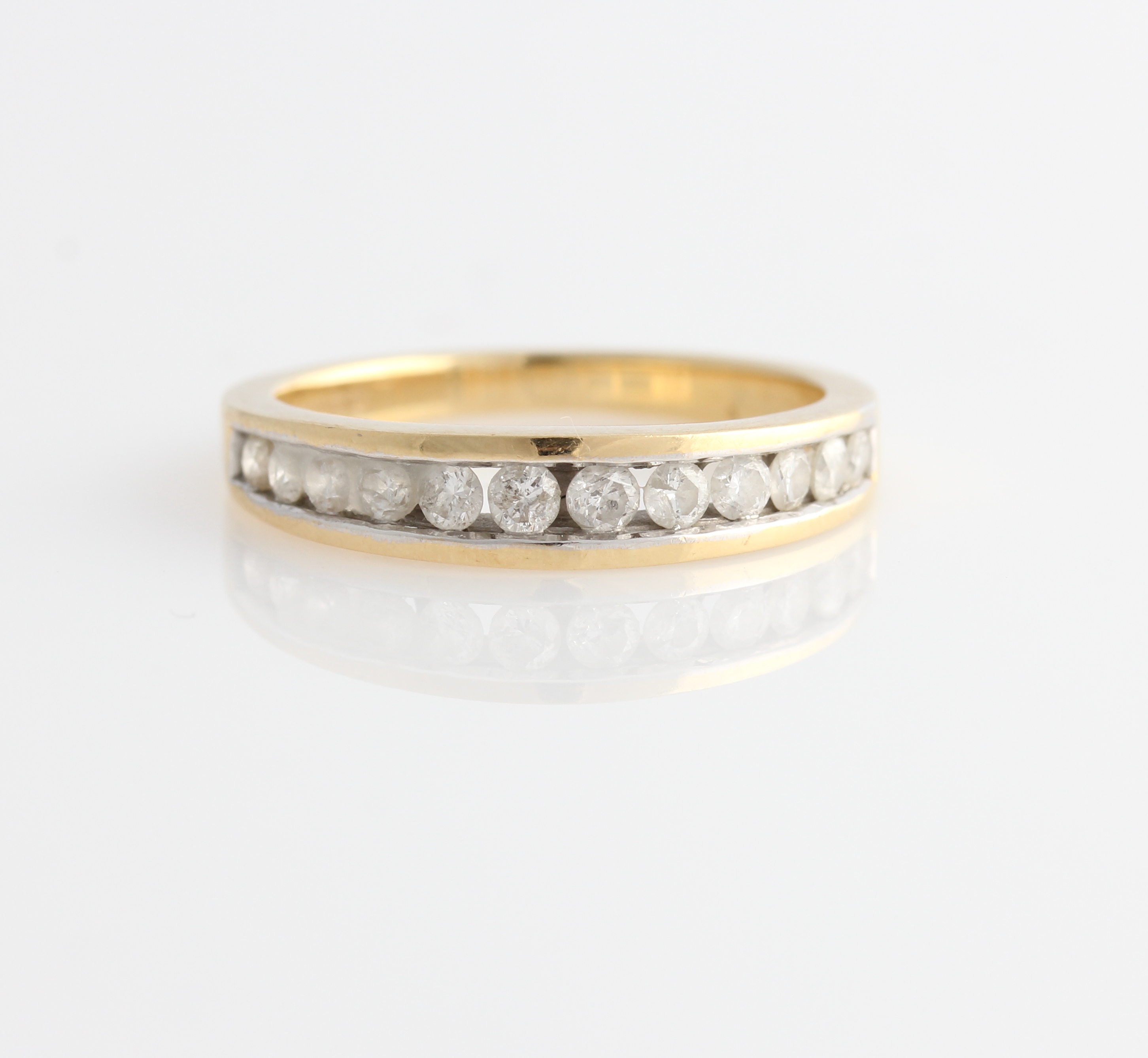 A hallmarked 18ct yellow gold diamond half eternity ring, channel set with twelve graduated round