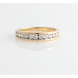 A hallmarked 18ct yellow gold diamond half eternity ring, channel set with twelve graduated round