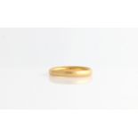 A hallmarked 22ct yellow gold wedding band of plain design.