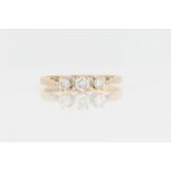 A hallmarked 9ct yellow gold three stone diamond ring, set with three graduated round brilliant