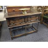 Early 20th Century oak two drawer serving base on barley twist supports.