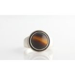 A Georg Jensen tigers eye ring, set centrally with a circular tigers eye cabochon, design no. 46,