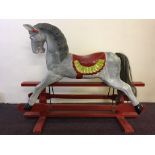 A wooden painted rocking horse. Length approximately 111cm.