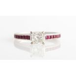 A hallmarked 18ct white gold, diamond and ruby ring, set with a princess cut diamond measuring