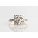 A diamond ring, set with nine variously sized old cut diamonds, in a square design head, with