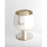 A silver goblet of tapered circular form, raised on textured stem and circular foot, hallmarked with