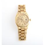 A gents 1970s Rolex Oyster Perpetual Day Date wrist watch, the gold-tone dial having hourly arrow