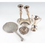 A collection of hallmarked silverware, to include a pair of weighted candlesticks, a weighted twin