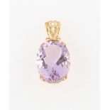 A hallmarked 9ct yellow gold set amethyst pendant, set with an oval cut amethyst measuring approx.