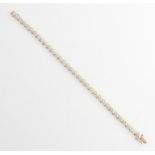A hallmarked 9ct yellow gold diamond line bracelet, each circular articulated link set with a