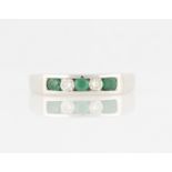 A hallmarked 18ct white gold emerald and diamond half eternity ring, set alternately with three