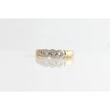 A hallmarked 9ct yellow gold three stone diamond ring, set with three round brilliant cut