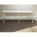 A white painted iron framed bench.