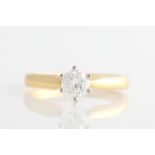 A hallmarked 18ct yellow gold diamond solitaire ring set with a round brilliant cut diamond