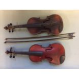 Two violins with bows.