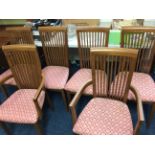 Teak extending dining table together with six chairs and sideboard base.