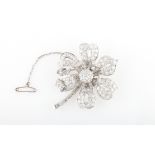 A diamond set flower design brooch, the open metalwork flower set with variously sized round