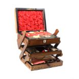 A Victorian walnut sewing box of rectangular form and of three cantilever sections, the front and