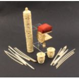 Four 19th Century Cantonese carved ivory pieces comprising a pin cushion clamp, 8cm, a pair of