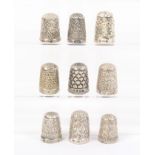 Nine silver and white metal thimbles comprising eight English hallmarked examples two holed, one