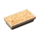 A fine 19th Century carved ivory needle case, of rectangular form over ogee sides, the sliding lid