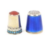 Two Norwegian white metal and enamel thimbles one with stone top, the frieze in white wave scrolls